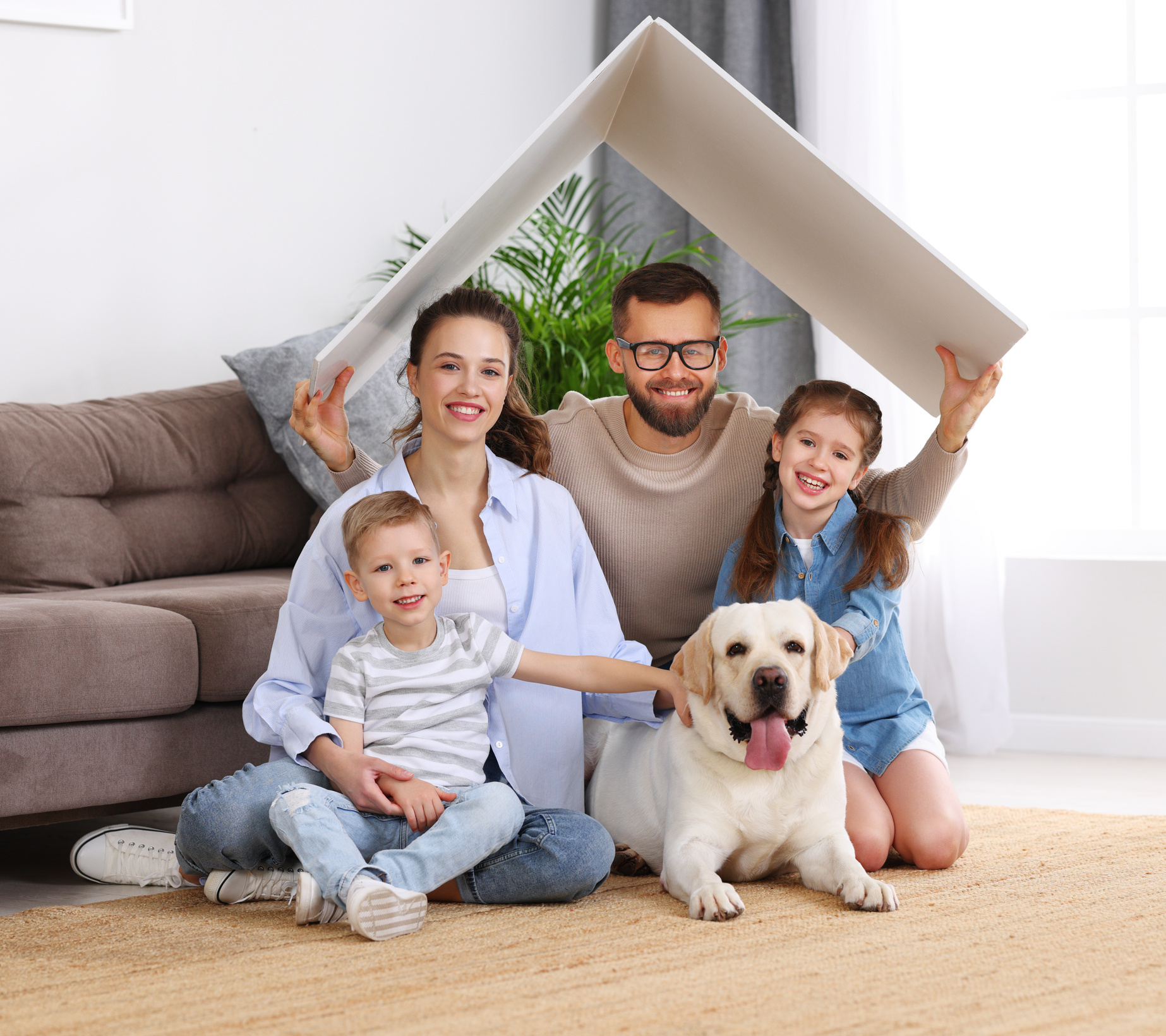 Happy family with dog enjoying new home